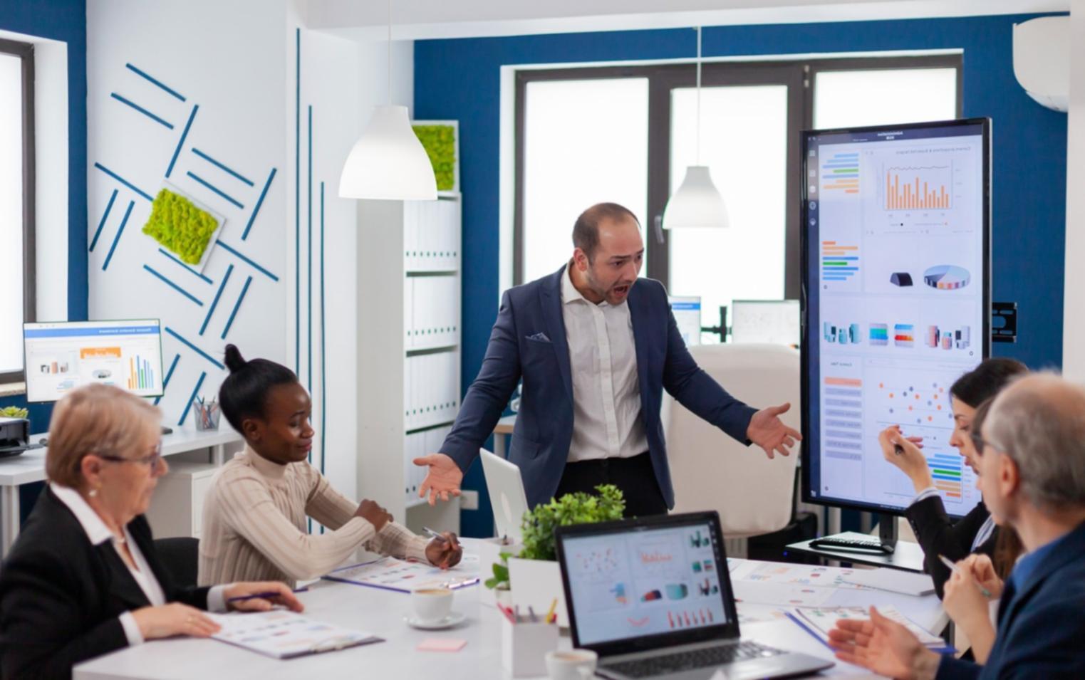 Business financial analysis with reports and planning documents spread on desk